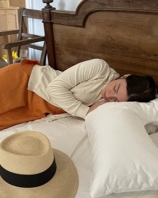woman napping on bed