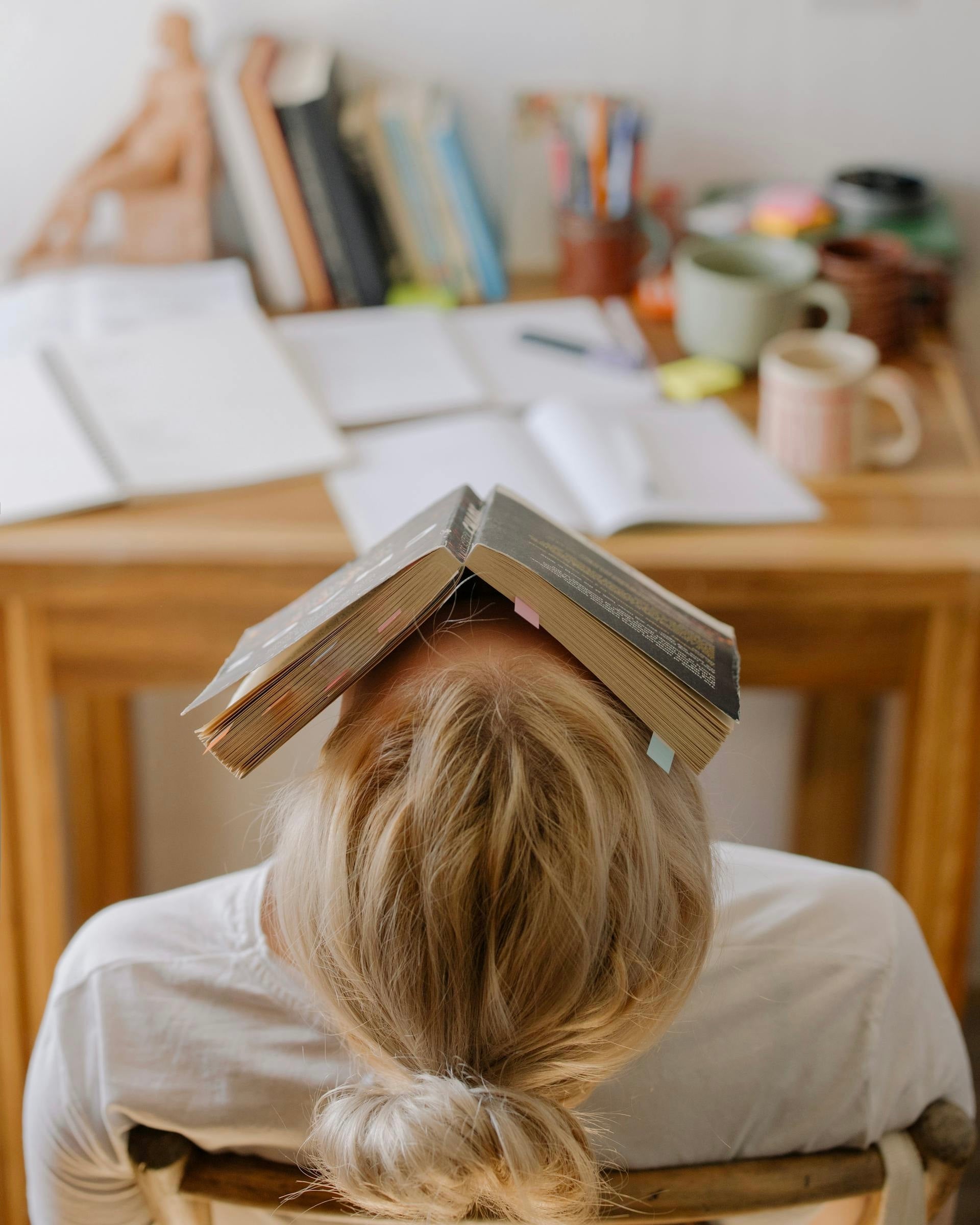 woman sleeping with book on face