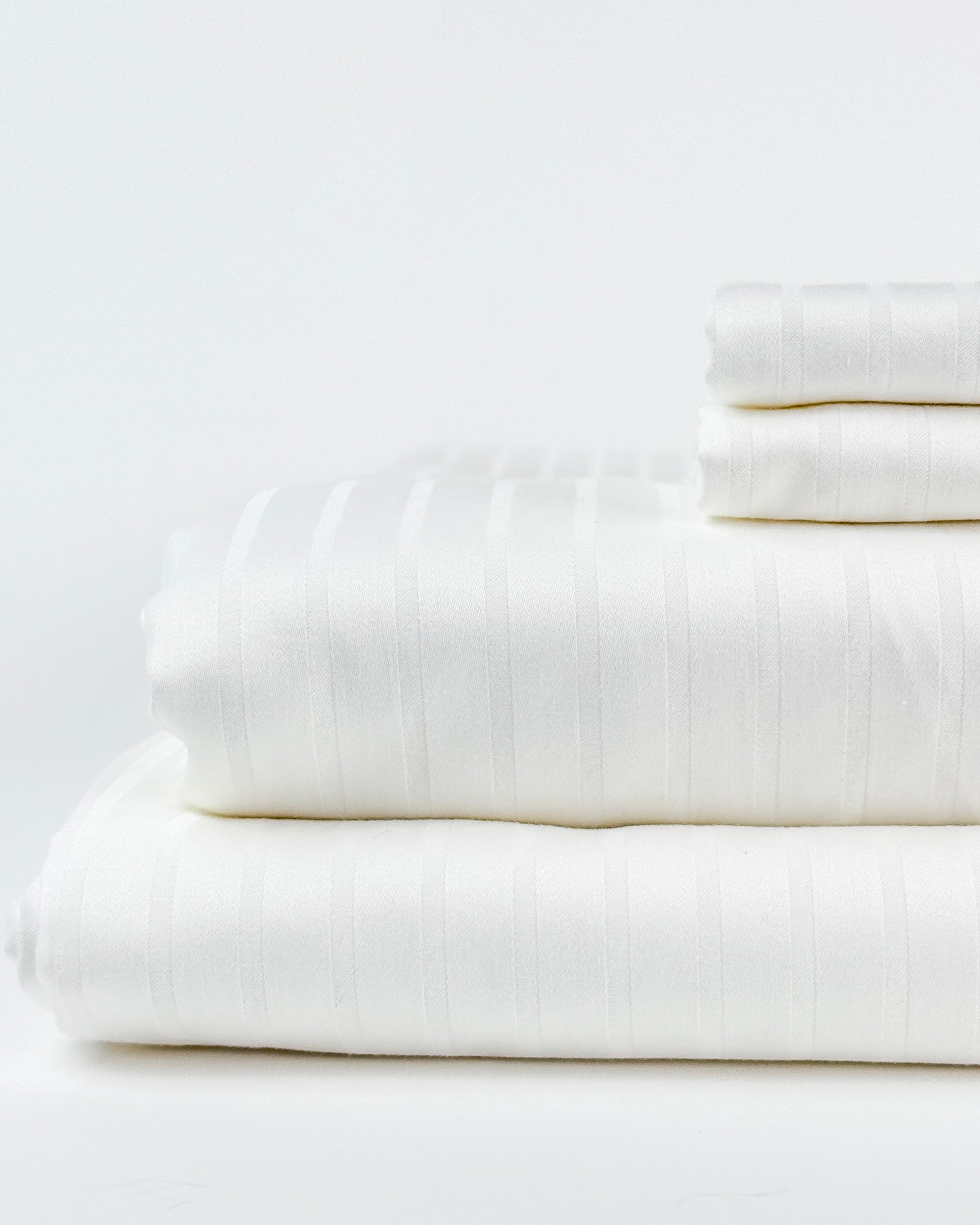 stack of regal sateen sheets
