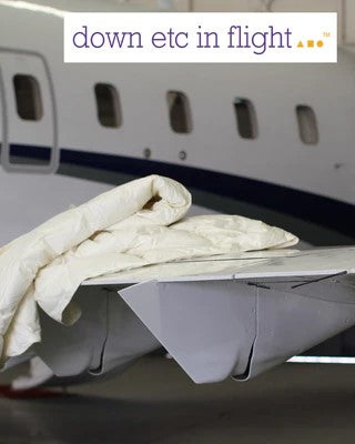 comforter on wing of airplane