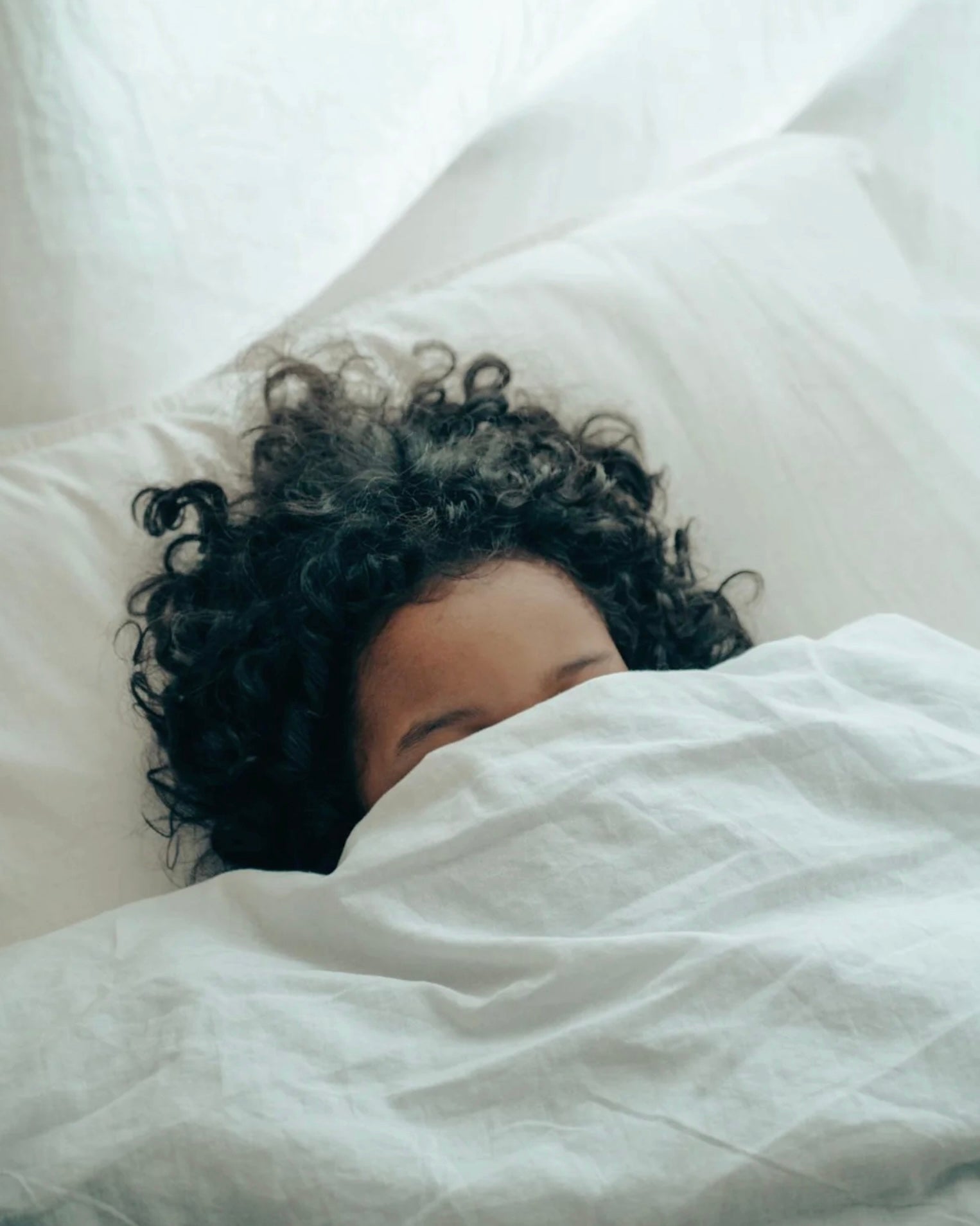 woman under bed covers