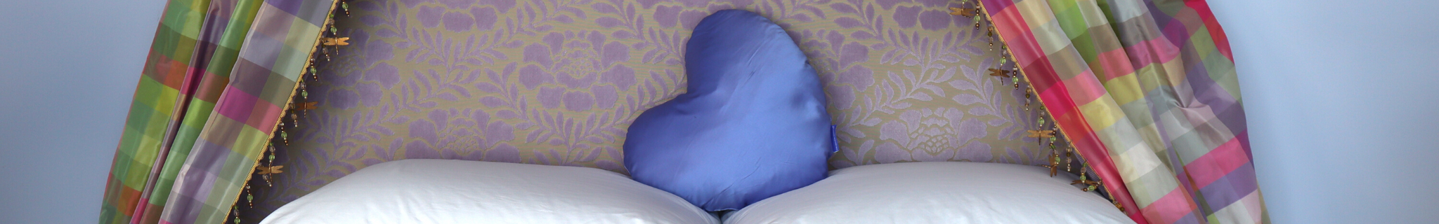 Periwinkle Heart Pillow on bed