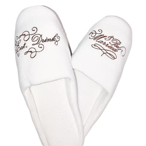 White slippers embroidered with Eat, Drink & Be Married